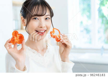 キッチンで料理をする若い女性 96246183