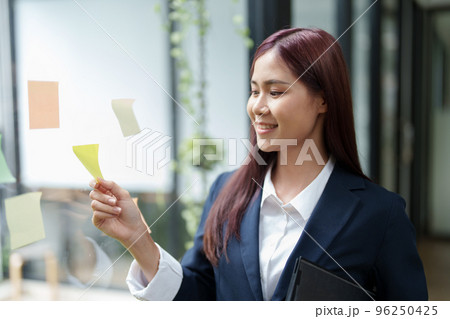 Portrait of an Asian businesswoman working at the office Grab a notepad to make a marketing plan. Portrait of an Asian businesswoman working at the office Grab a notepad to make a marketing plan. 96250425
