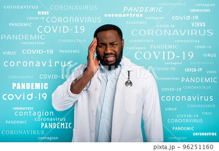 Doctor is exhausted due to overwork by coronavirus covid-19. Cyan background 96251160
