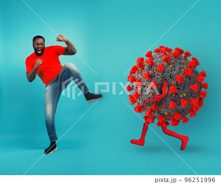 African-American man fighting with bare hands against a big virus on cyan background 96251996