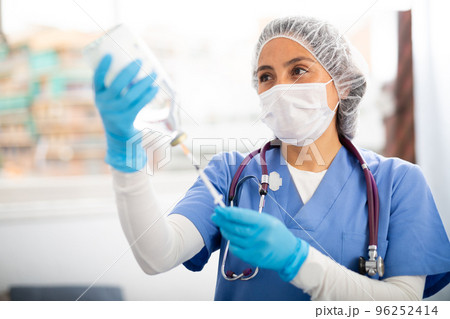 Professional nurse woman making injection in hospital Professional nurse woman making injection in hospital 96252414