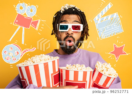 Boy has fun watching a film. concept of entertainment and streaming tv. Yellow background 96252771