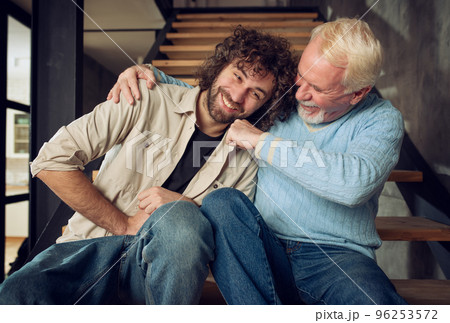 Father and son play together at home. Concept of family relationship Father and son play together at home. Concept of family relationship 96253572