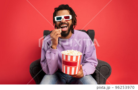 Boy has fun watching a film. Concept of entertainment and streaming tv Boy has fun watching a film. Concept of entertainment and streaming tv 96253970