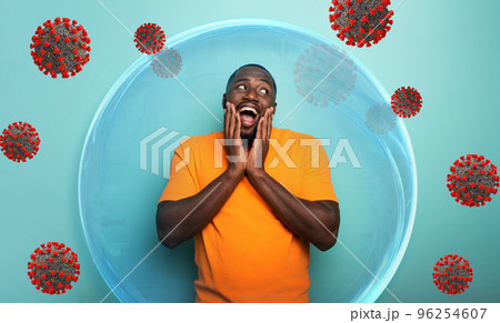 Man inside a glass sphere is secure and protected against covid19 coronaviruses. 96254607