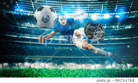 Soccer striker hits the ball with an acrobatic kick in the air at the stadium 96254768
