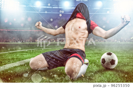 Soccer striker rejoices for the victory at the stadium Soccer striker rejoices for the victory at the stadium 96255350