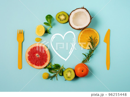 Composition of citrus fruit, orange and lemon, coconut, kiwi on cyan background Composition of citrus fruit, orange and lemon, coconut, kiwi on cyan background 96255448