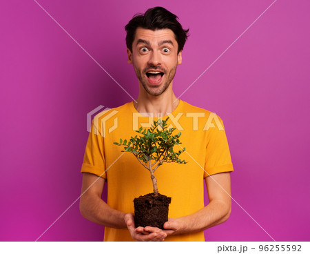 Happy boy holds a small tree ready to be planted over a light color. concept of forestation, ecology and conservation Happy boy holds a small tree ready to be planted over a light color. concept of forestation, ecology and conservation 96255592
