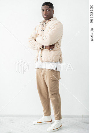 Confident man portrait. Trendy guy in beige outfit standing in studio 96258150