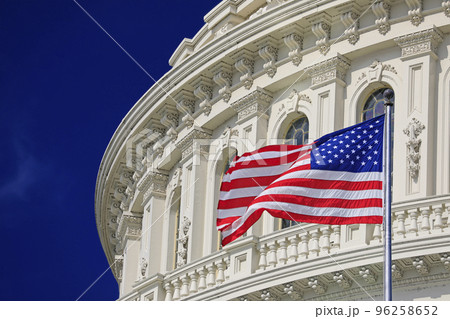 Washington DC Capitol dome detail with waving American flag 96258652