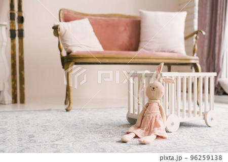 Soft homemade toy Bunny in a pink dress in the children's room Soft homemade toy Bunny in a pink dress in the children's room 96259138