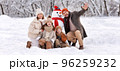 Happy family in warm clothes laughing merrily while making snowman together 96259232