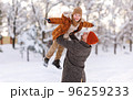 Little son having fun with dad while playing in winter park during New year and Christmas holidays 96259233