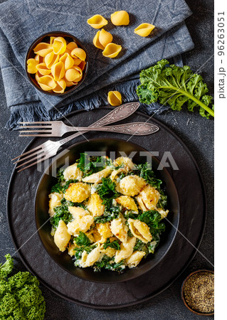 cheesy baked pasta with green leafy kale 96263051