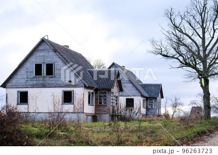 Abandoned, vandalized residential building. Broken glass, slum, desolation. Defocused. 96263723