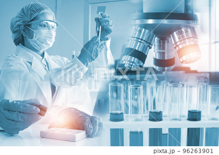 Double exposure microscope Young woman scientific using equipment in the laboratory for research. Double exposure microscope Young woman scientific using equipment in the laboratory for research. 96263901