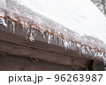 Close-up of melting snow icicles on roof. 96263987