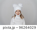 Portrait of beauty kid girl in wooly sweter and hat. 96264029