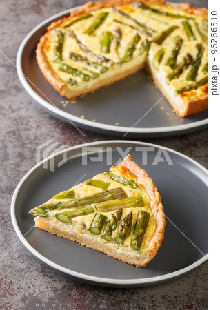 Baked pie egg custard is studded with fresh asparagus a perfect spring side dish or vegetarian main dish close-up in a plate. Vertical Baked pie egg custard is studded with fresh asparagus a perfect spring side dish or vegetarian main dish close-up in a plate. Vertical 96266510