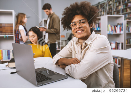 University students are studying in a library together. Concept of teamwork and preparation University students are studying in a library together. Concept of teamwork and preparation 96266724