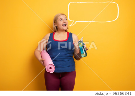 Fat girl does gym at home. satisfied expression. yellow background Fat girl does gym at home. satisfied expression. yellow background 96266841