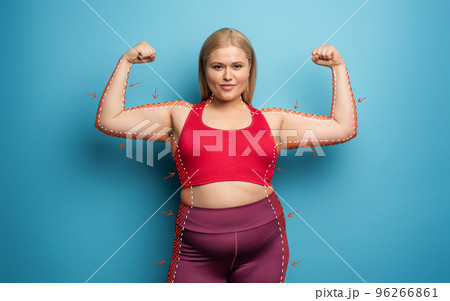 Determinated girl wants to remove fat and does gym at home. satisfied expression. cyan background 96266861