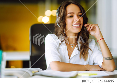 Young operator woman agent with headsets working in a call centre. Call center service. 96266895