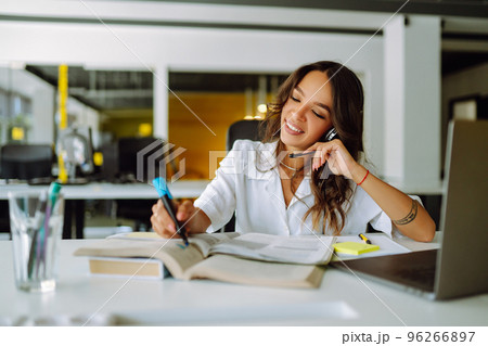 Young operator woman agent with headsets working in a call centre. Call center service. 96266897