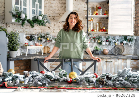 woman is decorating room for Christmas woman is decorating room for Christmas 96267329