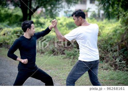 Young man training self defense fighting technique.. 96268161