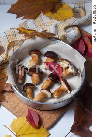 Vintage baking sheet with Imleria Badia or Boletus badius mushrooms commonly known as the bay bolete on wooden cutting board.. Vintage baking sheet with Imleria Badia or Boletus badius mushrooms commonly known as the bay bolete on wooden cutting board.. 96268965