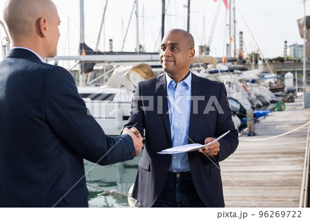two men in suits buy and sell a yacht in the seaport two men in suits buy and sell a yacht in the seaport 96269722