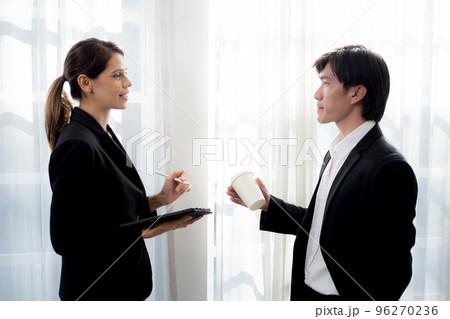 Young manager talking with secretary about report marketing on digital tablet for planning. Young manager talking with secretary about report marketing on digital tablet for planning. 96270236