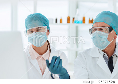 group of scientists using a computer to classify data. group of scientists using a computer to classify data. 96271520