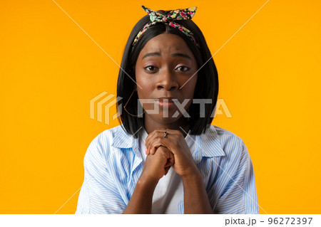 Young african woman on a yellow background confused, feels doubtful and unsure 96272397