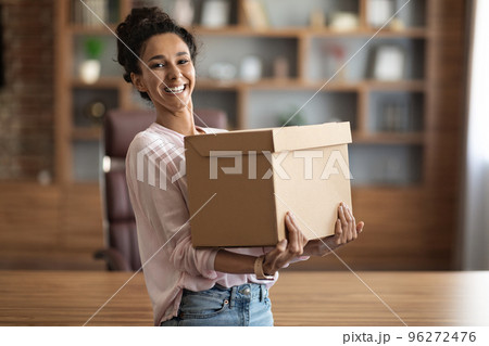 Happy young woman holding box parcel and smiling 96272476