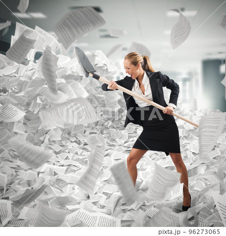 Worker submerged in paperwork makes her way with a shovel Worker submerged in paperwork makes her way with a shovel 96273065