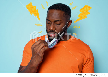 Boy is tired to breathe through the mask. cyan background Boy is tired to breathe through the mask. cyan background 96273097