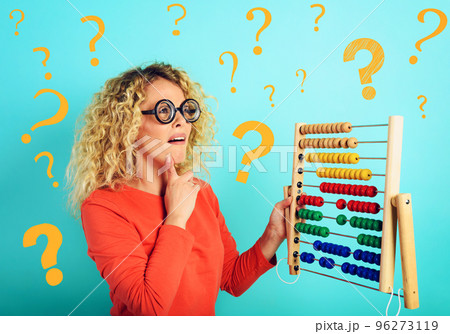 Girl with abacus is confused about the sum . cyan background 96273119