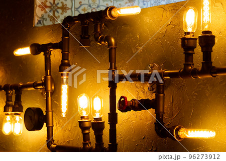 Modern led light made from water pipes. Rustic design, stucco wall with light bulbs and pipes 96273912