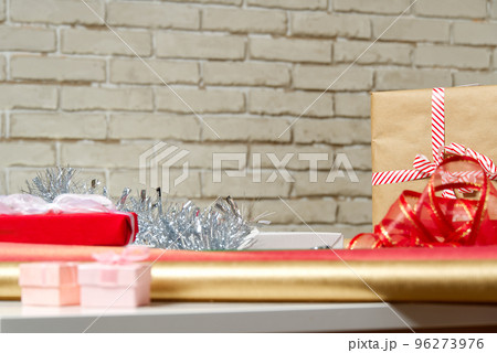 DIY Gift Wrapping station. Beautiful christmas gifts Christmas wrapping station concept side view with copy space DIY Gift Wrapping station. Beautiful christmas gifts Christmas wrapping station concept side view with copy space 96273976