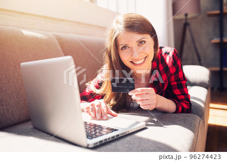 Girl is ready to pay with credit card on an online store 96274423