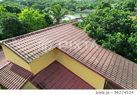 Old red tile home roof 96274534