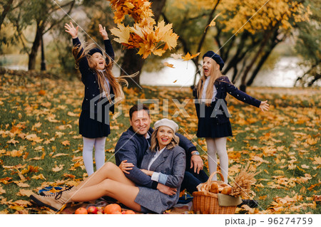 A big family on a picnic in the fall in a nature park. Happy people in the autumn park 96274759
