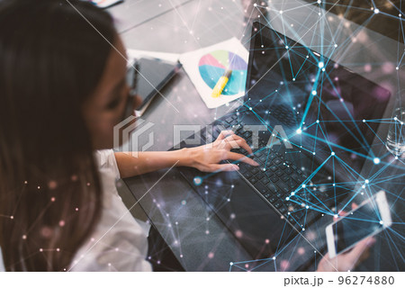 Businesswoman works in office with a laptop with internet effects. Concept of internet sharing and company startup Businesswoman works in office with a laptop with internet effects. Concept of internet sharing and company startup 96274880