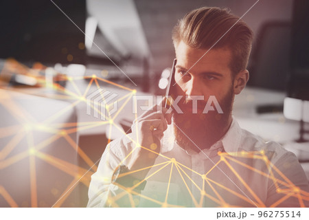 Businessman talking to the phone in office Businessman talking to the phone in office 96275514