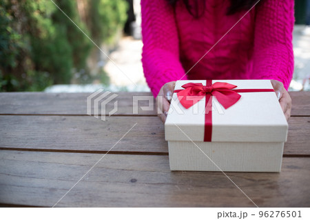 Women holding white gift box for Christmas, Birthday, Valentine's Day Concept. Women holding white gift box for Christmas, Birthday, Valentine's Day Concept. 96276501
