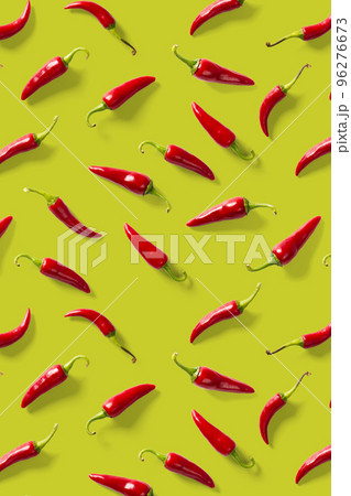 Creative background made of red chili or chilli on green backdrop. Minimal food backgroud. Red hot chilli peppers background. 96276673