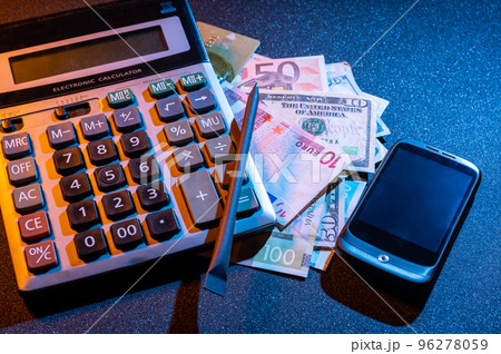 Calculator, money and smartphone. Count money. Calculate profits and costs. Income and taxes. Calculator, money and smartphone. Count money. Calculate profits and costs. Income and taxes. 96278059